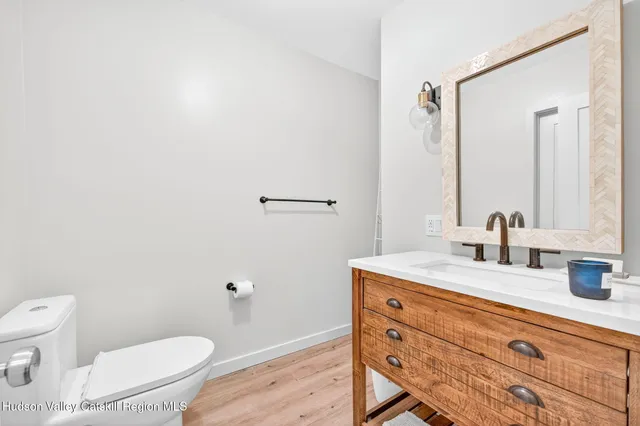 a bathroom with a sink a toilet and mirror