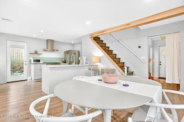 a living room with dining room and wooden floor