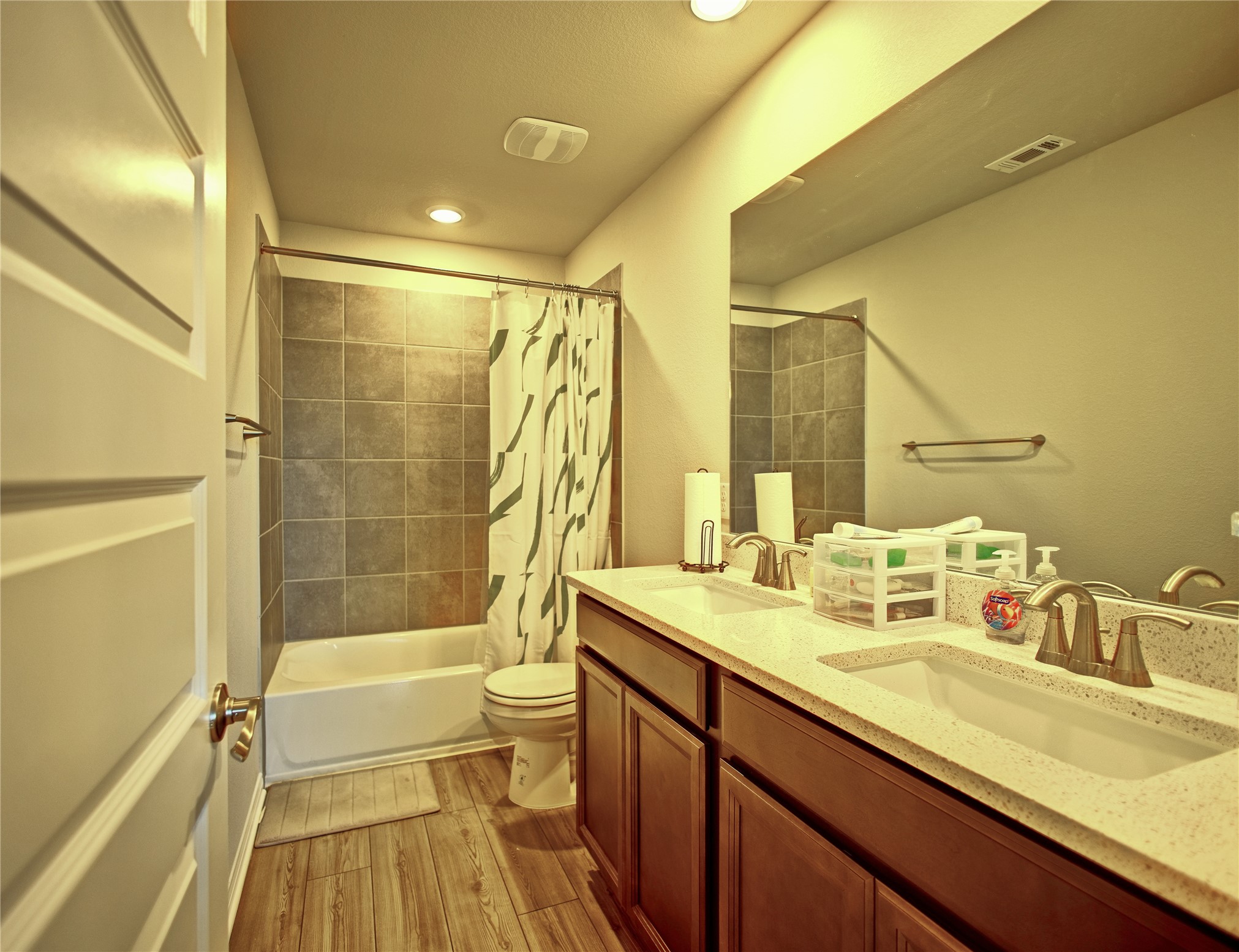 2809 Moyer Lane Round Rock, TX 78665 - Photo 15 of 22 Bathroom featuring double vanity, shower / tub combo with curtain, light wood-style floors, and recessed lighting