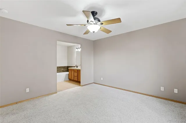 an empty room with closet and windows