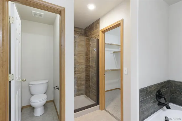 a bathroom with a toilet shower and a sink
