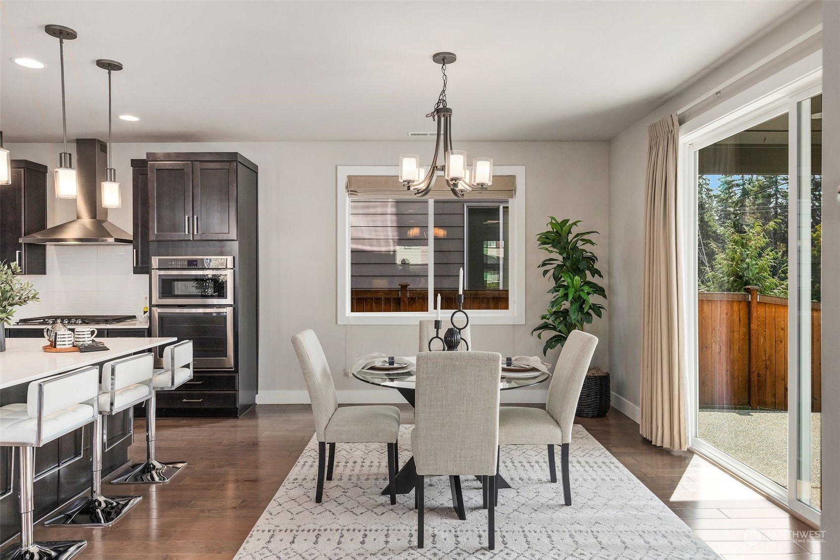 22322 43rd Drive Southeast Bothell, WA 98021 - Photo 11 of 40 a dining room with furniture a chandelier and wooden floor