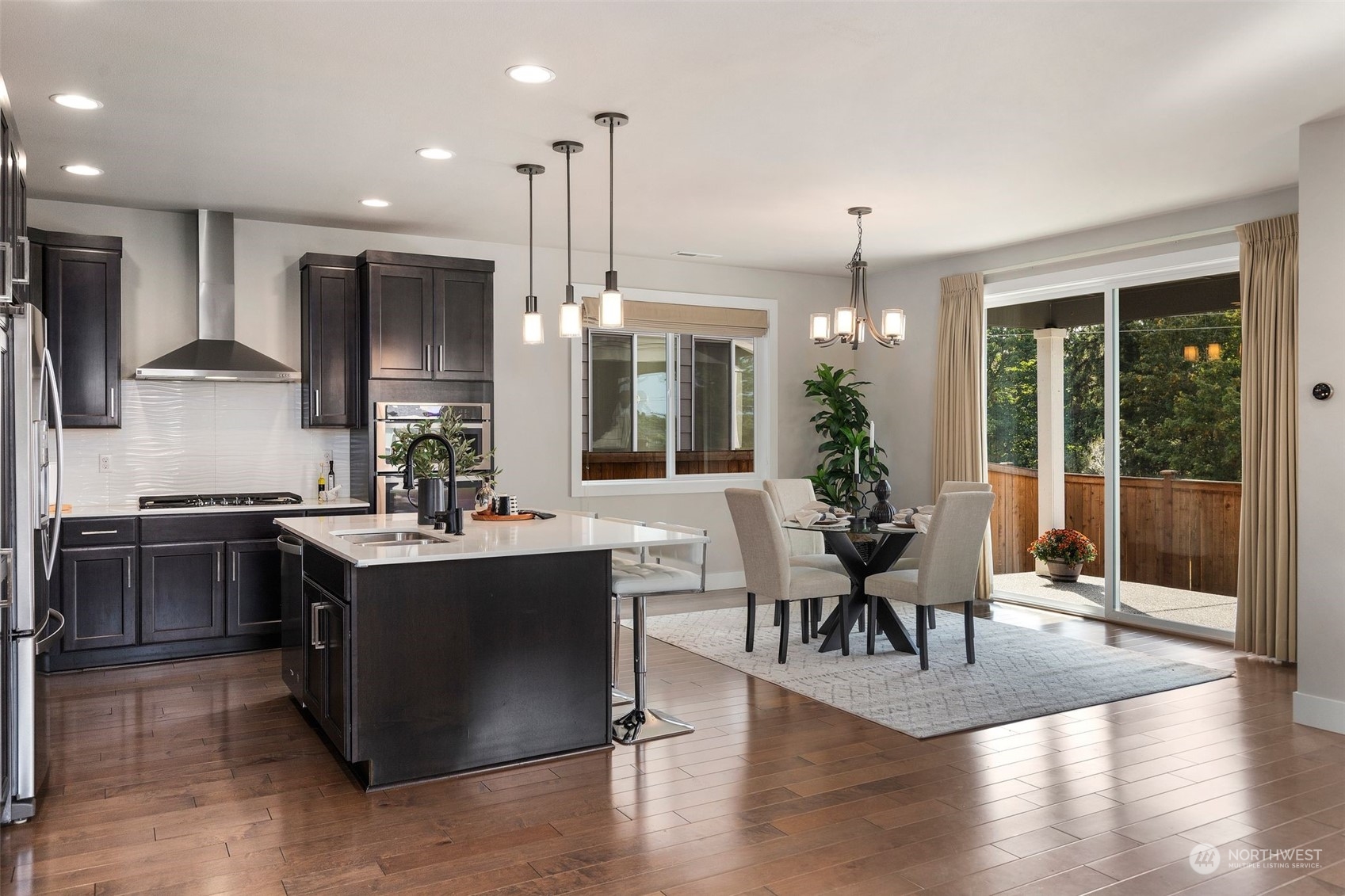 22322 43rd Drive Southeast Bothell, WA 98021 - Photo 12 of 40 a view of a kitchen and dining room with wooden floor
