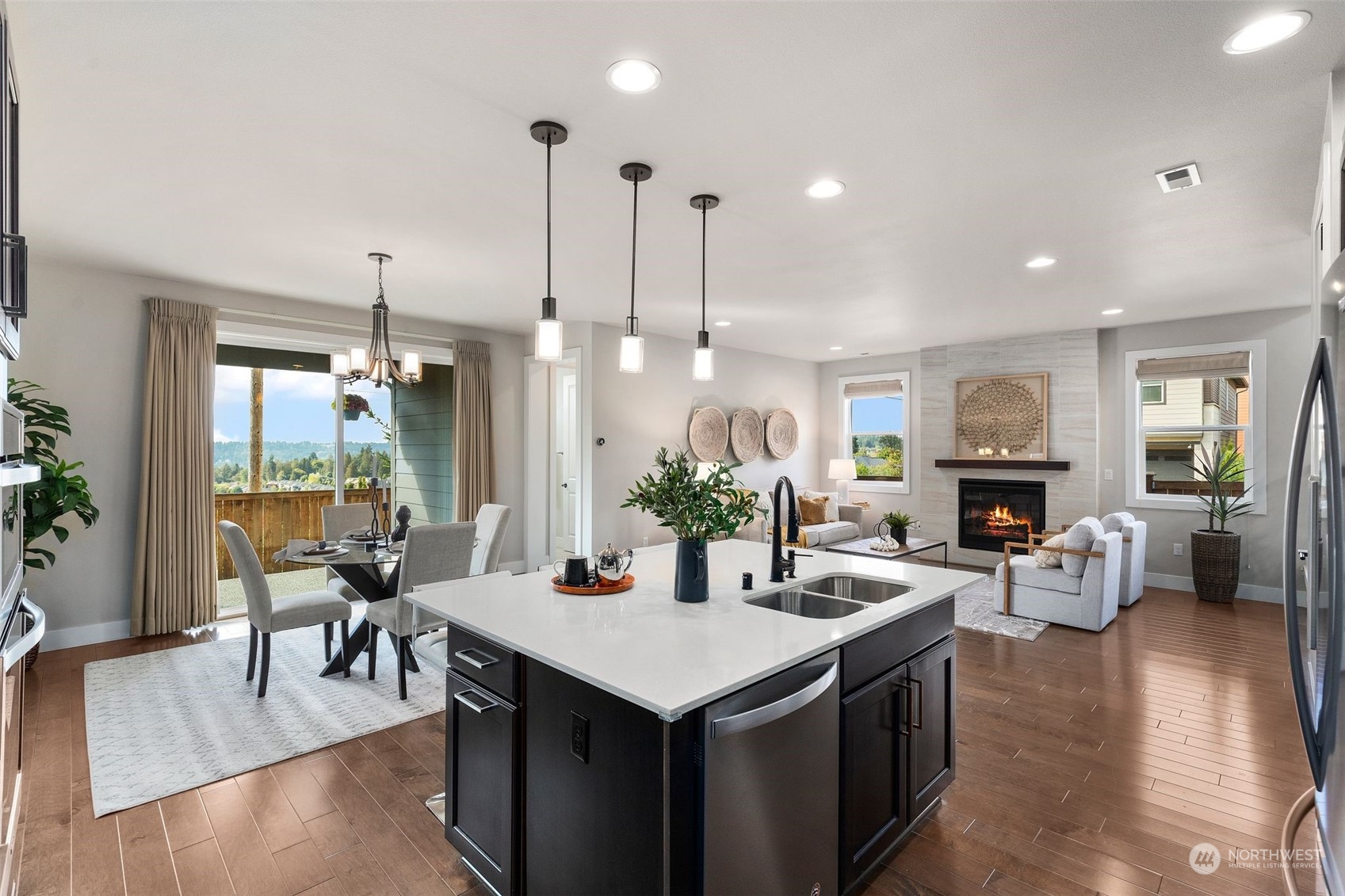 22322 43rd Drive Southeast Bothell, WA 98021 - Photo 14 of 40 a open kitchen with stainless steel appliances granite countertop a stove refrigerator and couches with wooden floor