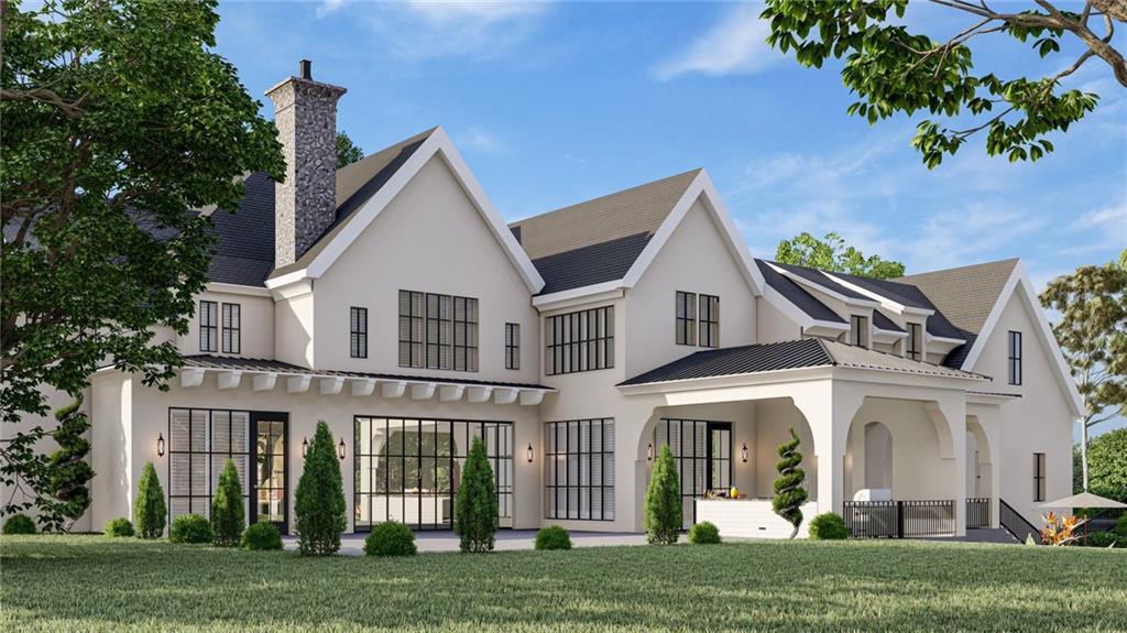 a view of a white house with a big yard and potted plants