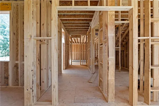 a view of a hallway with wooden walls and windows