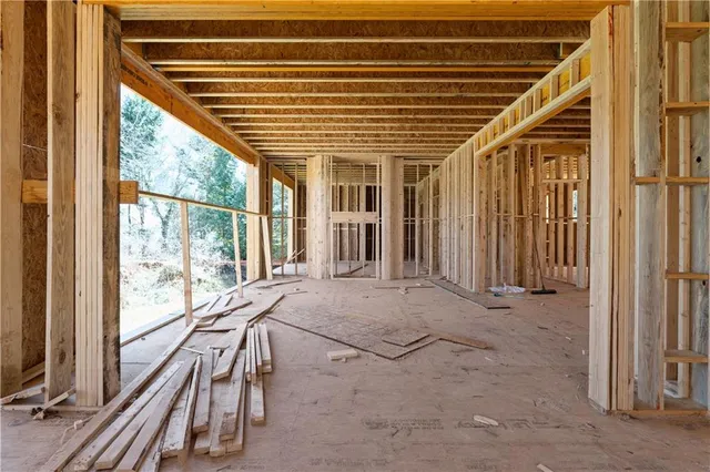 a bath room with a balcony a bed and glass door