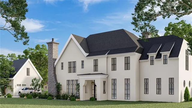 a front view of white house with a yard