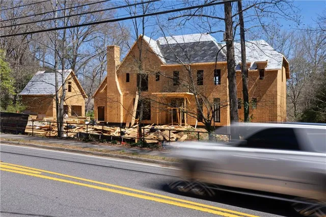 an aerial view of a house with wooden fence