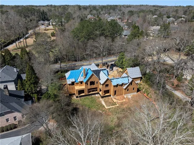 an aerial view of a house with a yard and sitting area