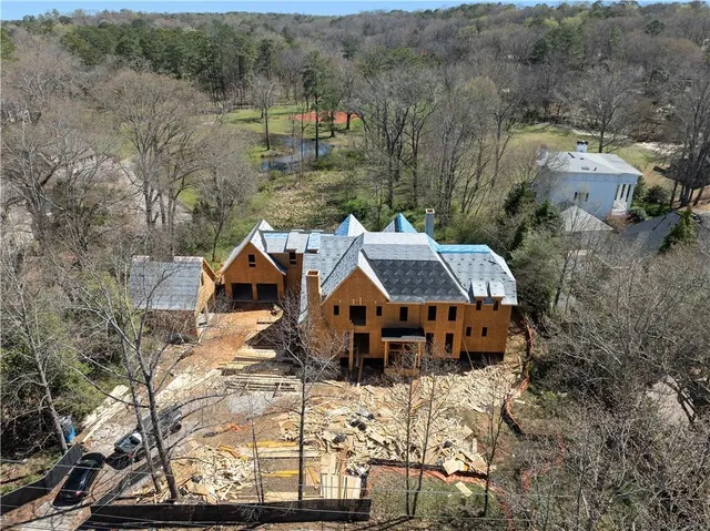 an aerial view of a house with a yard