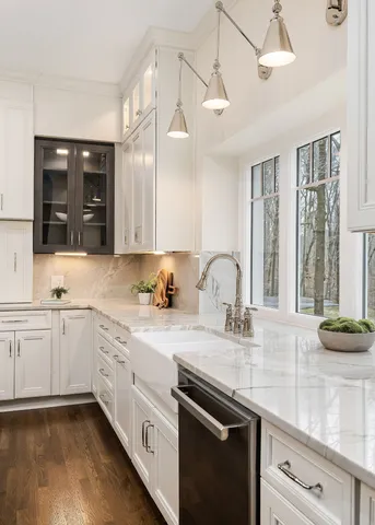 a living room with fireplace a large window and a chandelier