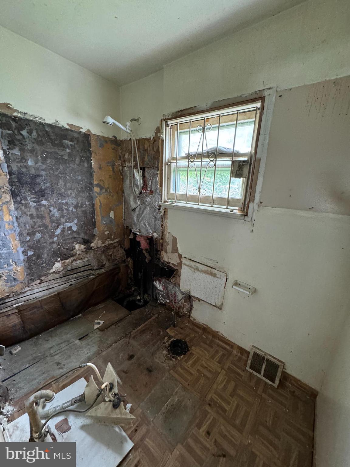2161 North Dover Street Philadelphia, PA 19121 - Photo 4 of 6 a room with water heater and wooden floor