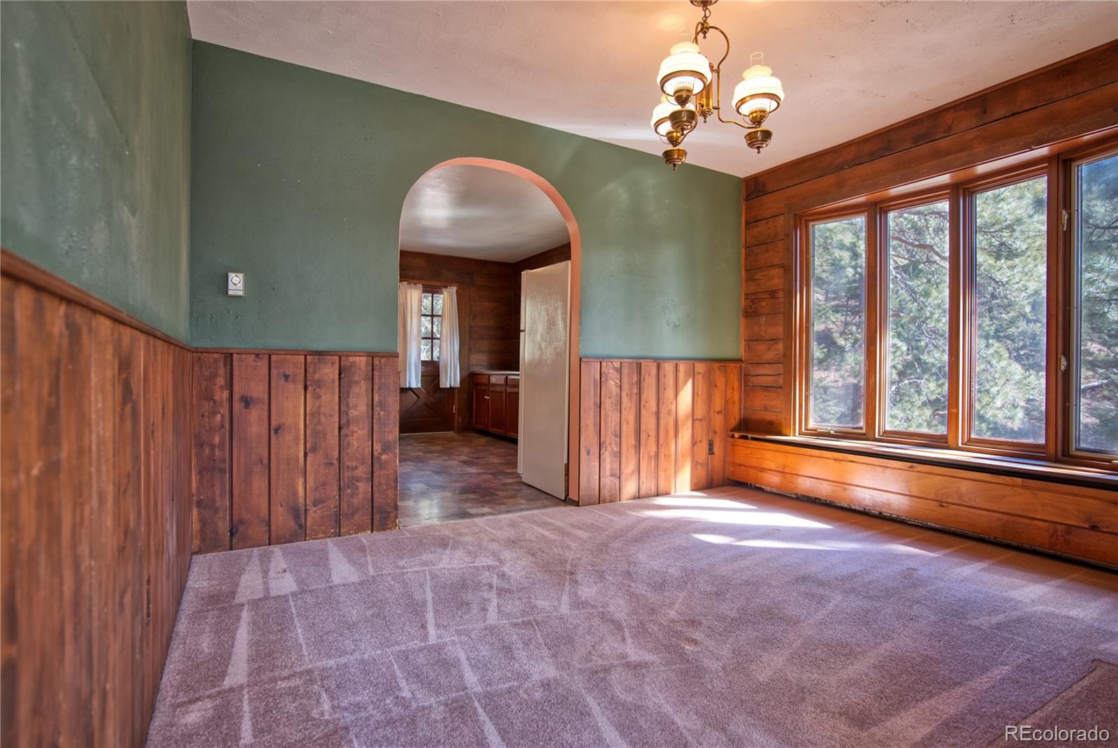 601 Pika Road Boulder, CO 80302 - Photo 11 of 30 a view of an empty room with a window and wooden floor