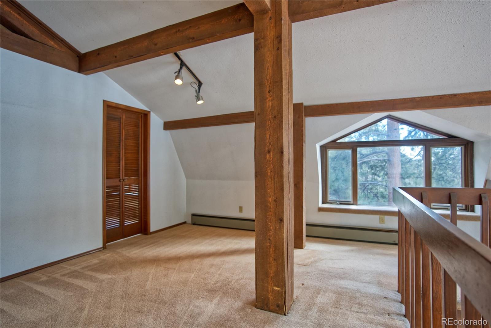 601 Pika Road Boulder, CO 80302 - Photo 15 of 30 a view of an empty room with a window and balcony