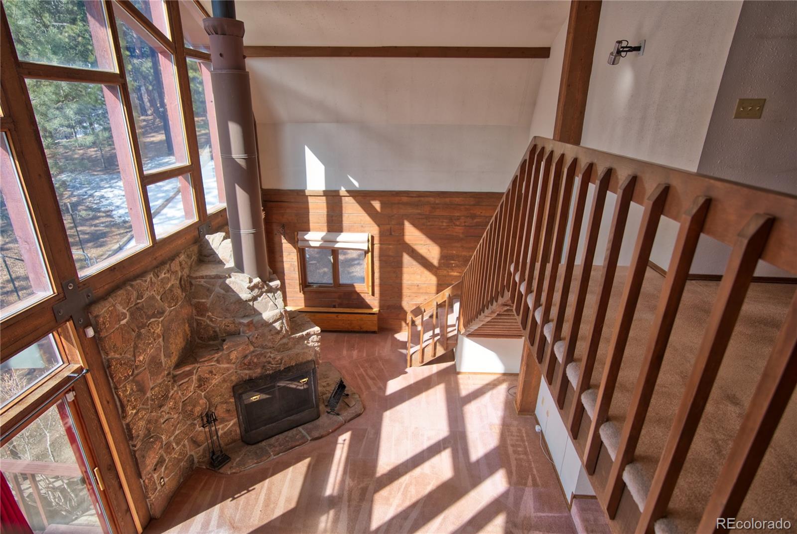 601 Pika Road Boulder, CO 80302 - Photo 16 of 30 a view of stairs and with wooden floor