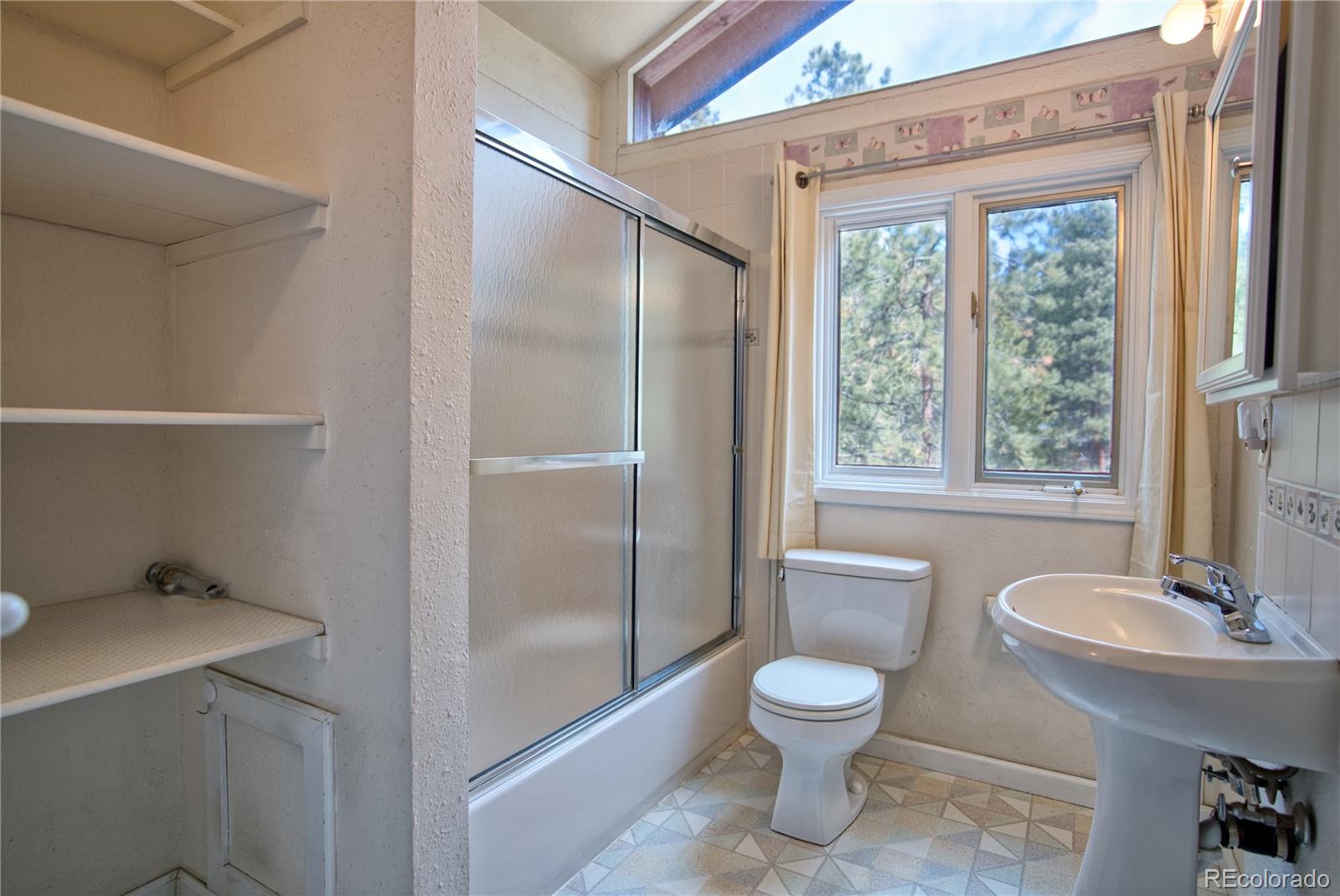 601 Pika Road Boulder, CO 80302 - Photo 21 of 30 a bathroom with a toilet a sink and a mirror
