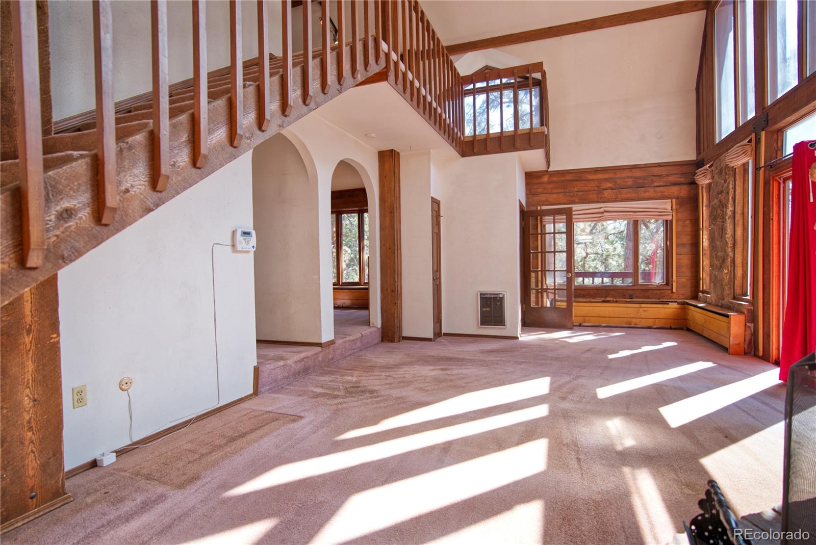 601 Pika Road Boulder, CO 80302 - Photo 8 of 30 a view of a hallway with windows and stairs