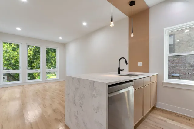 a kitchen with a sink and large window