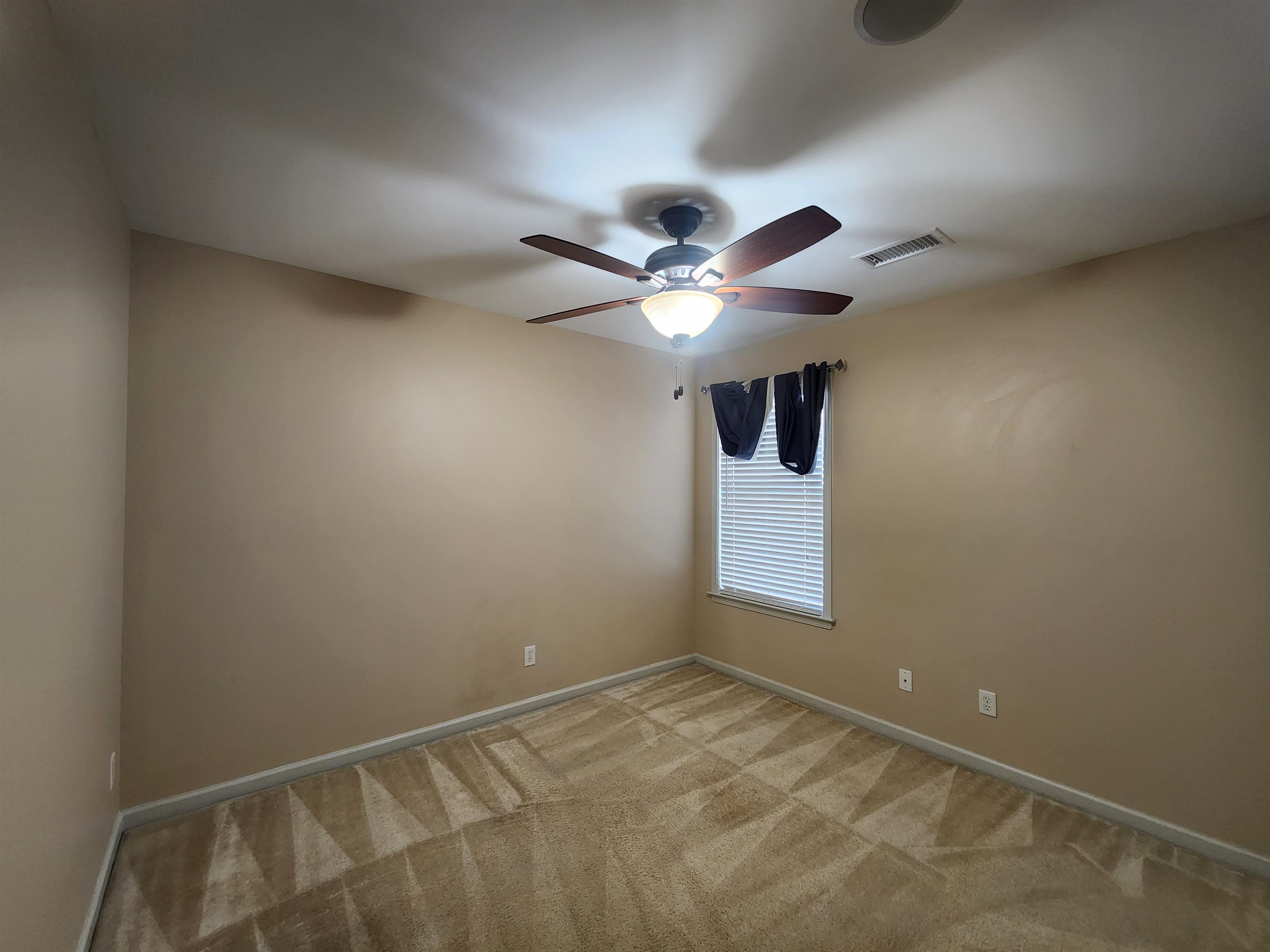 1459 Down River Drive Memphis, TN 38103 - Photo 21 of 27 Unfurnished room featuring light colored carpet, visible vents, baseboards, and a ceiling fan