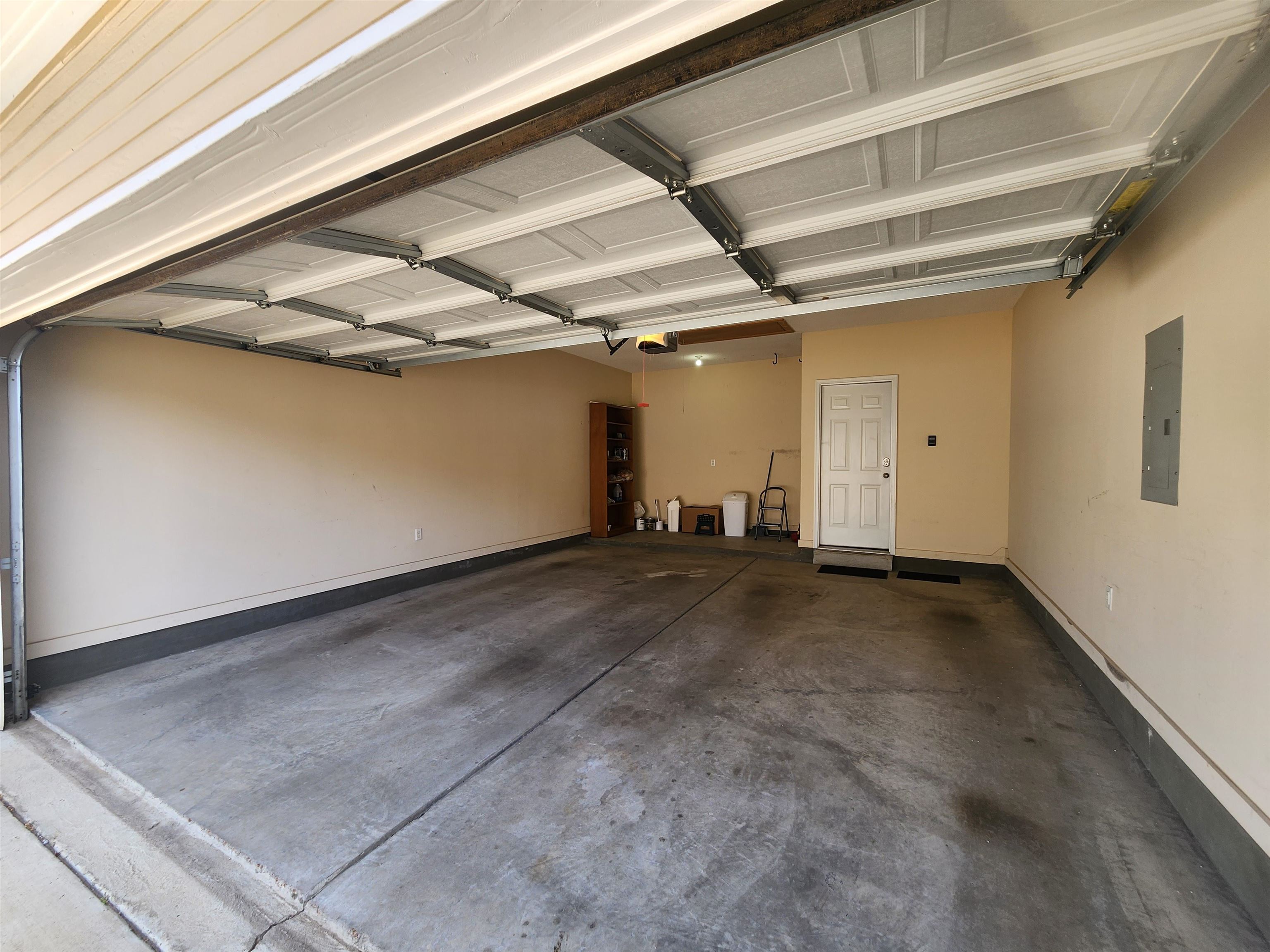 1459 Down River Drive Memphis, TN 38103 - Photo 26 of 27 Garage featuring baseboards, a garage door opener, and electric panel