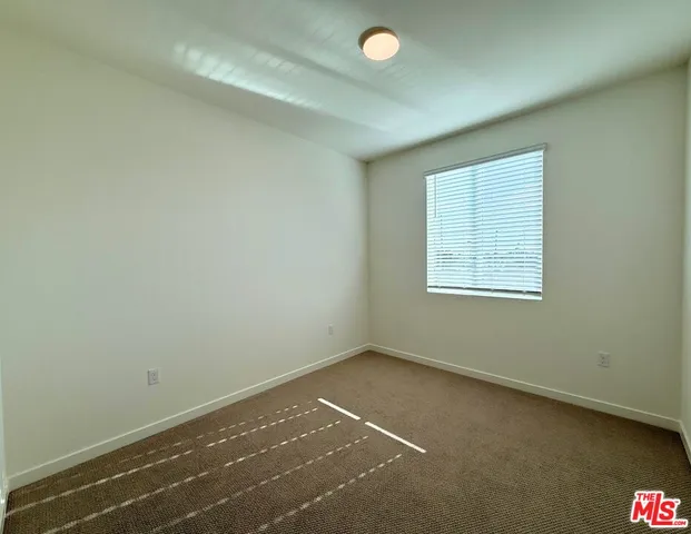 an empty room with a empty space and a window