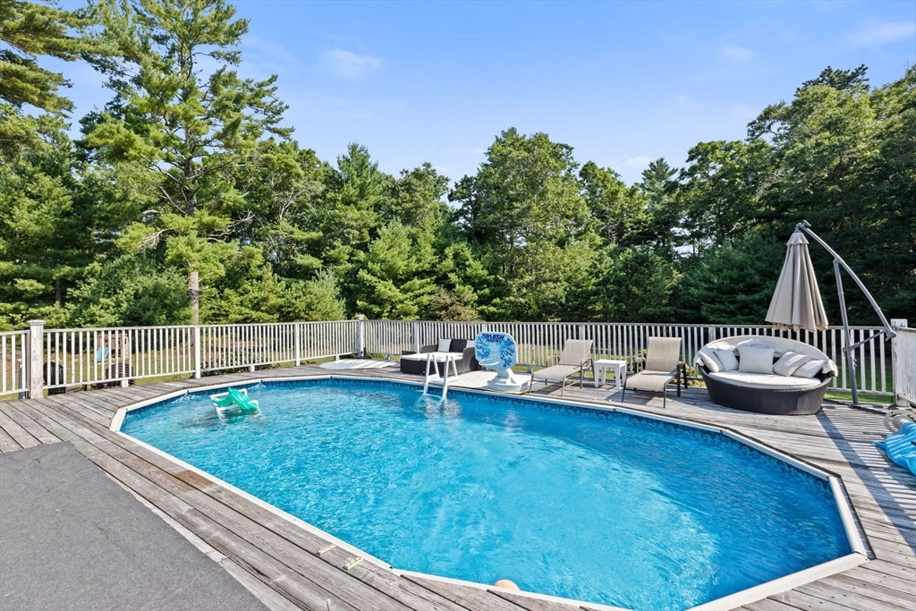 518 County Road Wareham, MA 02576 - Photo 23 of 32 a view of swimming pool with lawn chairs and wooden fence
