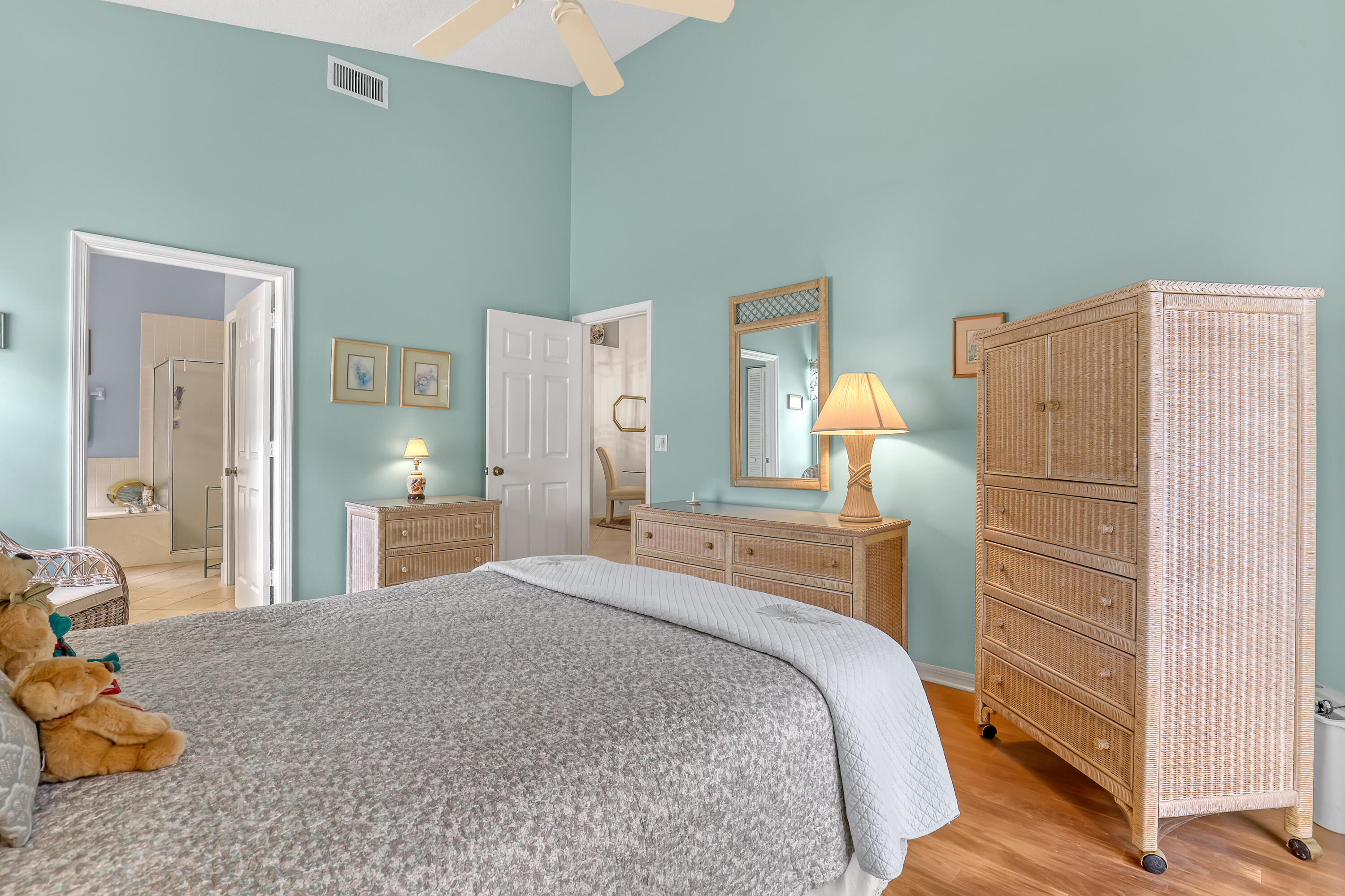 6995 Southeast Cutler Trail Stuart, FL 34997 - Photo 22 of 41 a bedroom with a bed and wooden floor