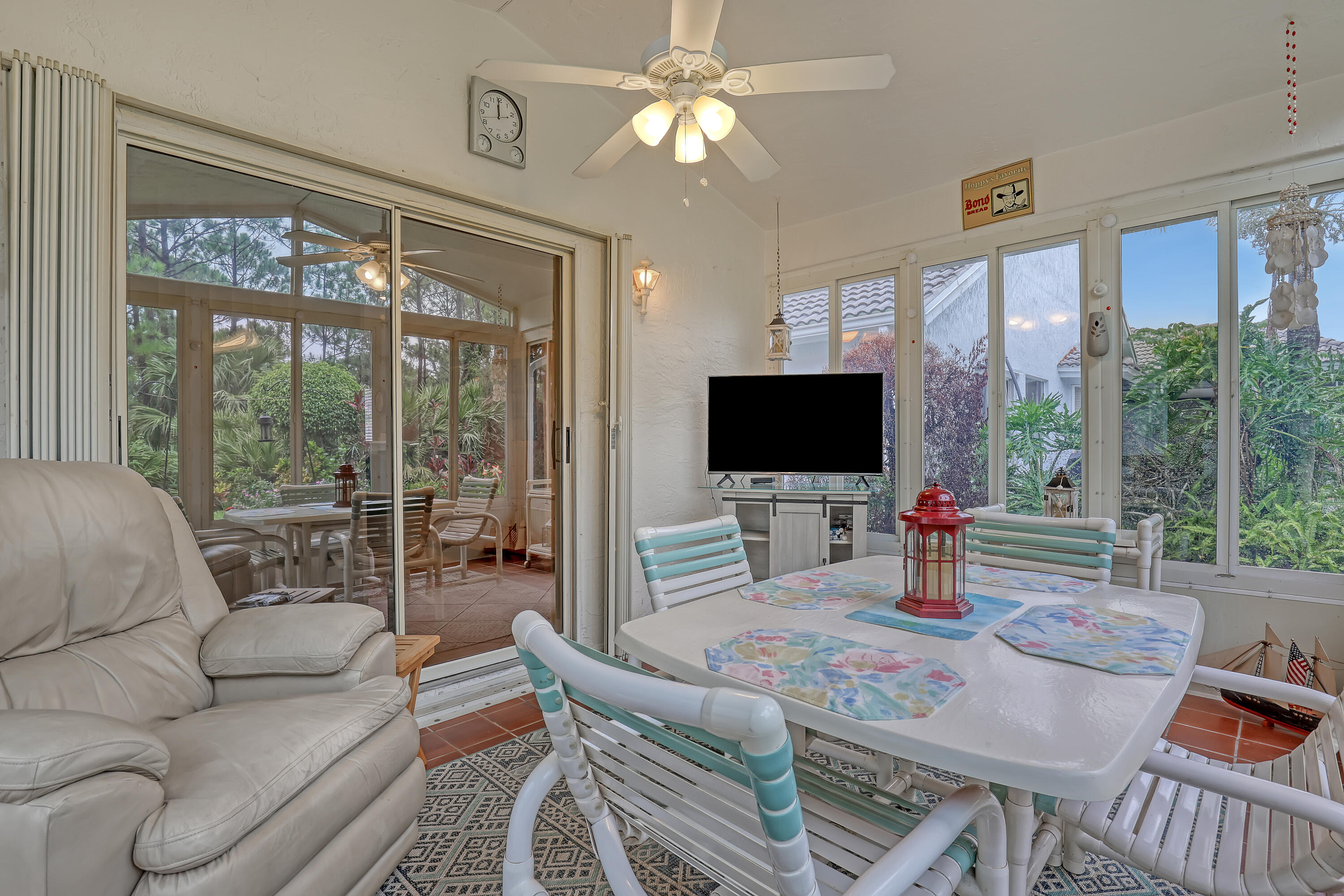 6995 Southeast Cutler Trail Stuart, FL 34997 - Photo 30 of 41 a living room with furniture a flat screen tv and a large window