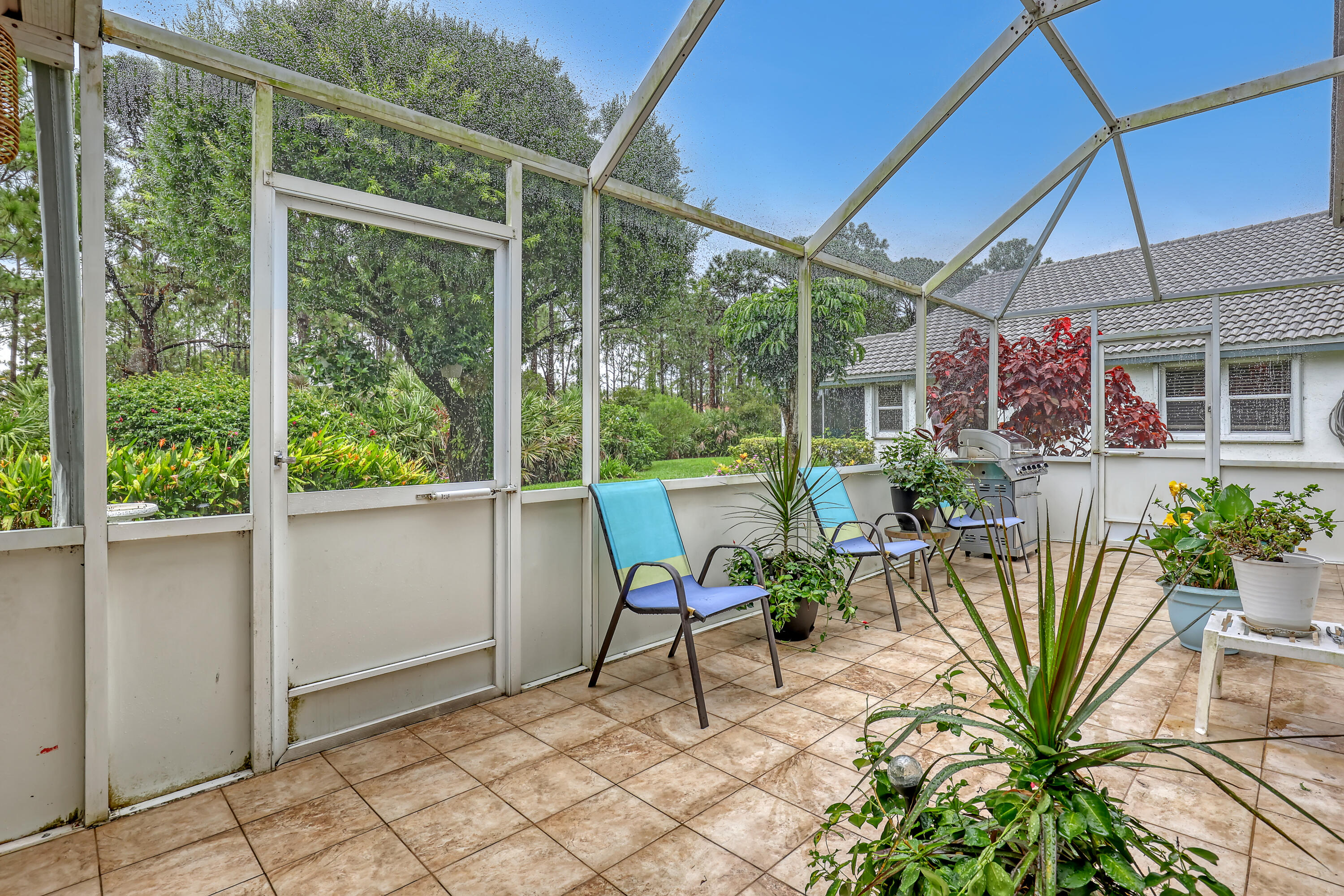 6995 Southeast Cutler Trail Stuart, FL 34997 - Photo 31 of 41 a view of a porch with chairs and potted plants