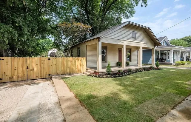 a view of a house with yard and sitting area