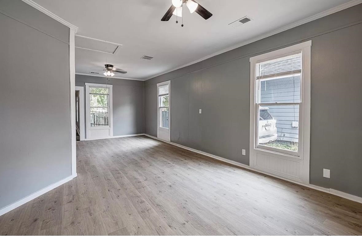 1033 Bruce Street Memphis, TN 38104 - Photo 4 of 9 a view of an empty room with chandelier fan and window