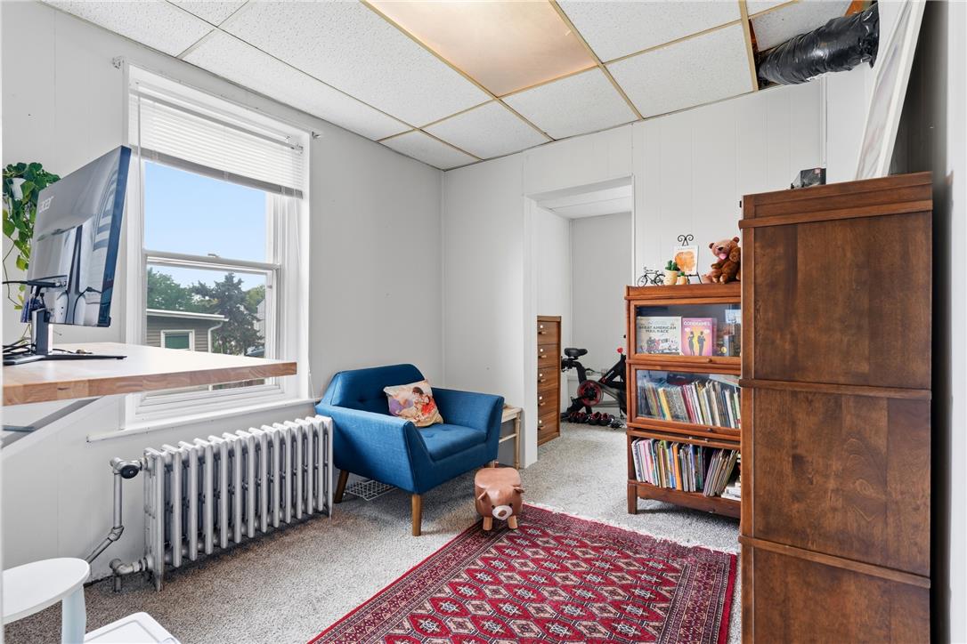 809 Hayes Street Bethlehem, PA 18015 - Photo 17 of 31 Natural light streams through a large window into a versatile room with carpet flooring.