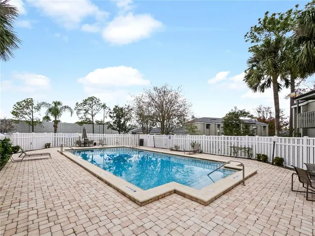 a view of a swimming pool with a lounge chairs