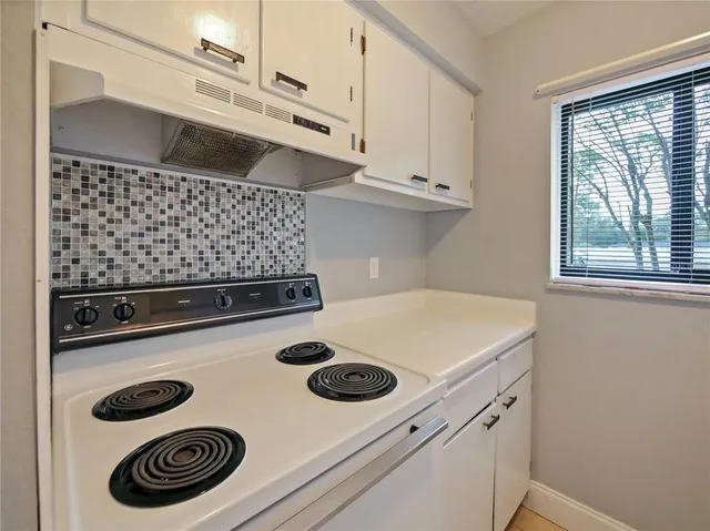 a kitchen with a stove and a microwave