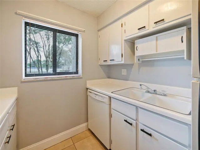 a utility room with cabinets washer and dryer