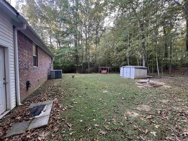 a backyard of a house with lots of green space