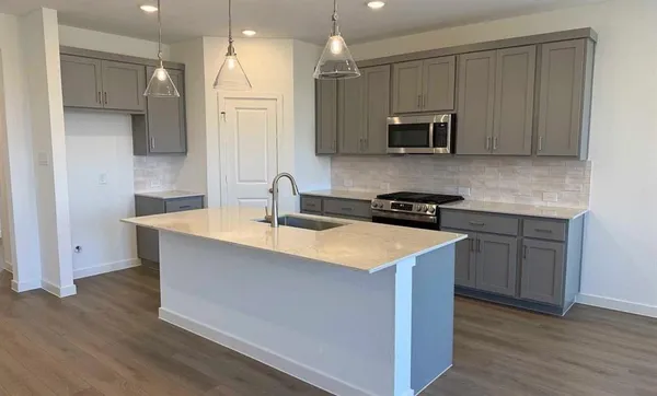 a close view of a sink a faucet and appliance in the kitchen
