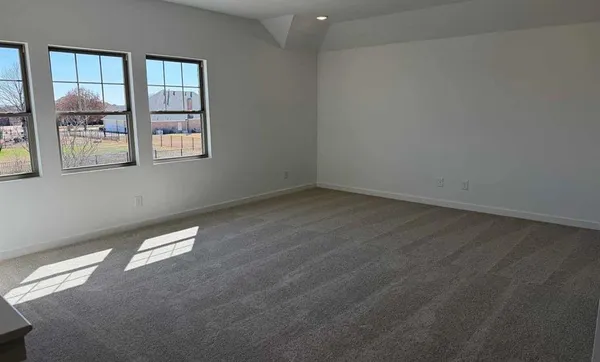 an empty room with a window and balcony view