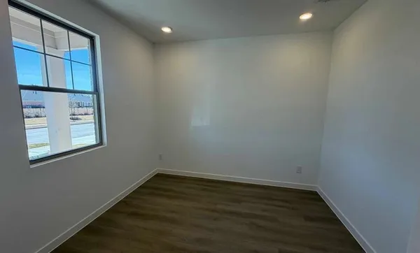 a kitchen with kitchen island granite countertop a sink and refrigerator