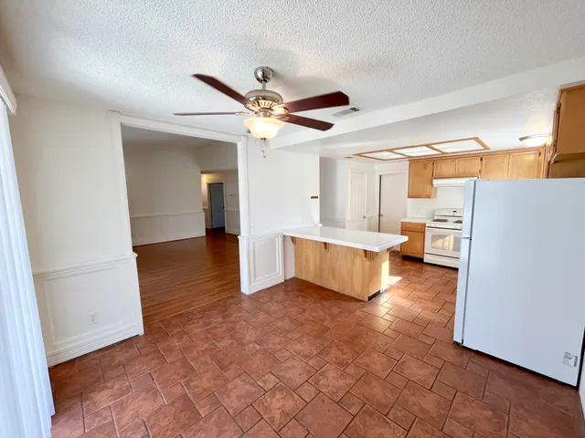 a kitchen with a stove a sink and a refrigerator