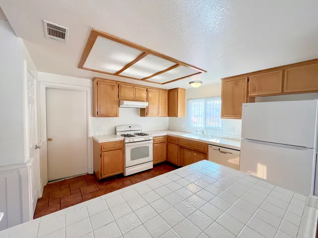 a kitchen with sink cabinets and window