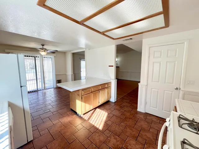 a kitchen with a cabinets and white appliances