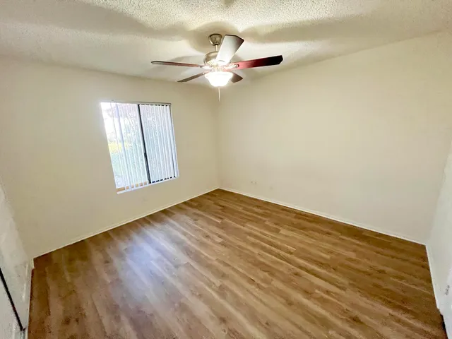 a view of a room with wooden floor