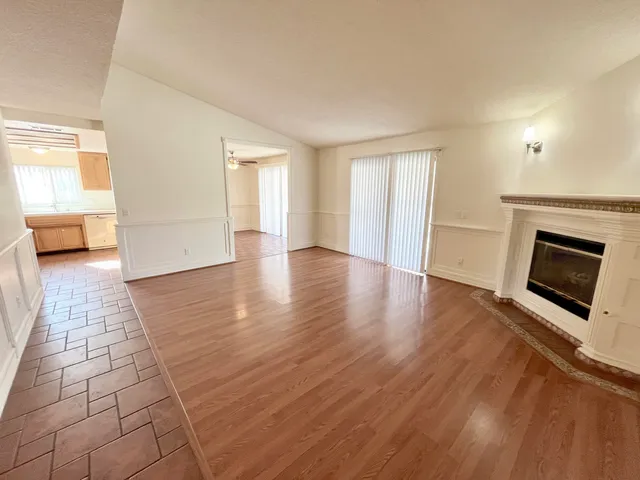 an empty room with windows and a fireplace