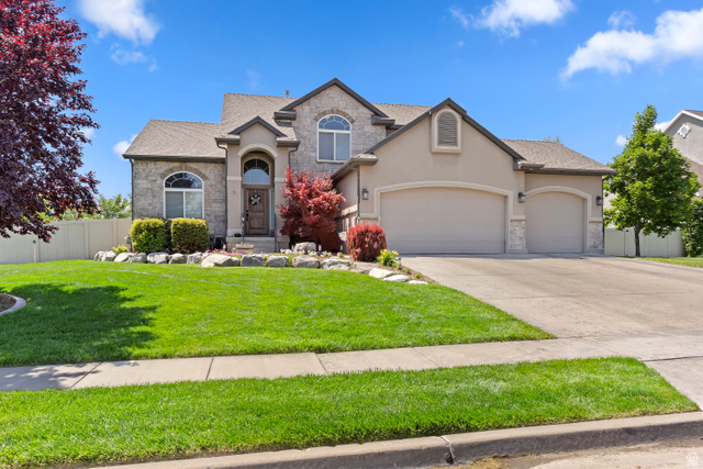163 Cold Creek Way Layton, UT 84041 - Photo 1 of 1 Traditional home with stone siding, a garage, stucco siding, and concrete driveway