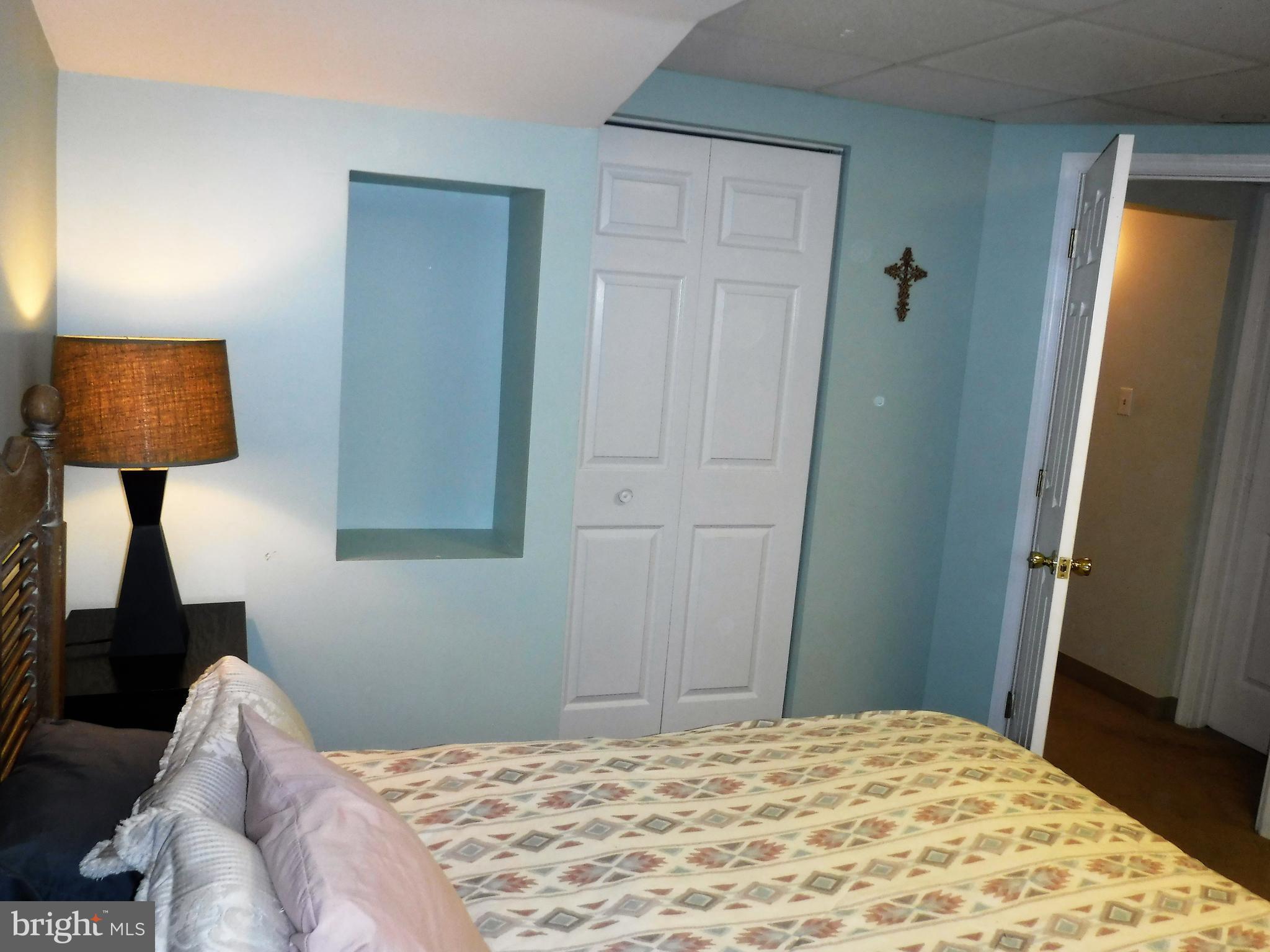 1222 Furnace Road Linthicum Heights, MD 21090 - Photo 8 of 9 a bedroom with a bed and a lamp