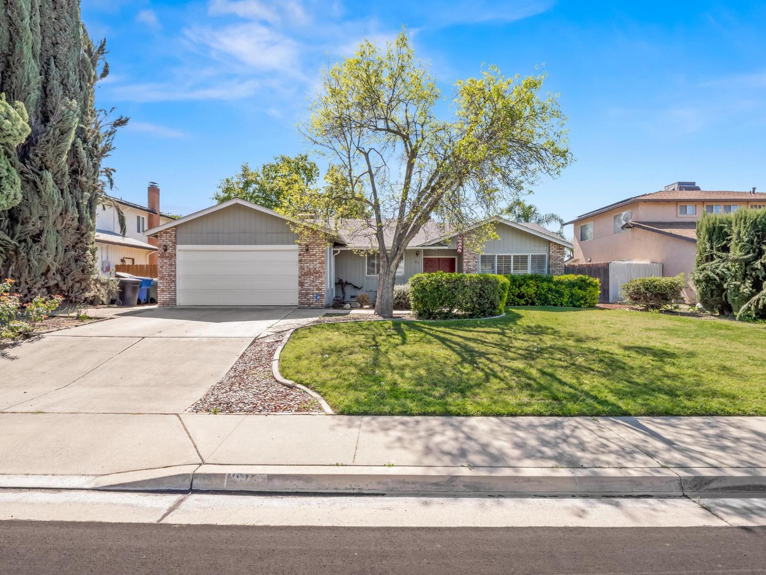 873 Cedar Lane Lemoore, CA 93245 - Photo 1 of 41 a view of a house with a garden