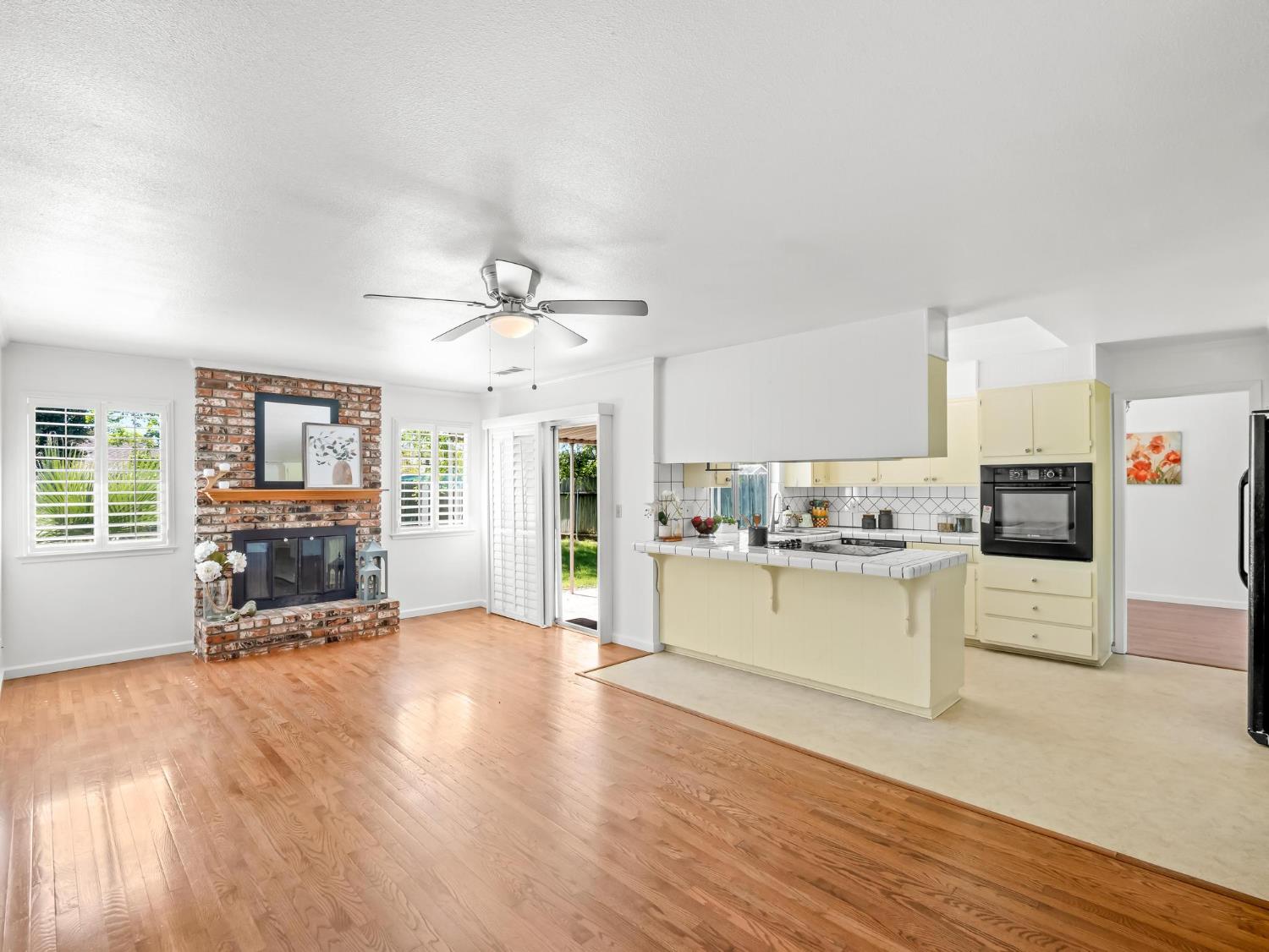 873 Cedar Lane Lemoore, CA 93245 - Photo 19 of 41 a large kitchen with cabinets wooden floor and stainless steel appliances
