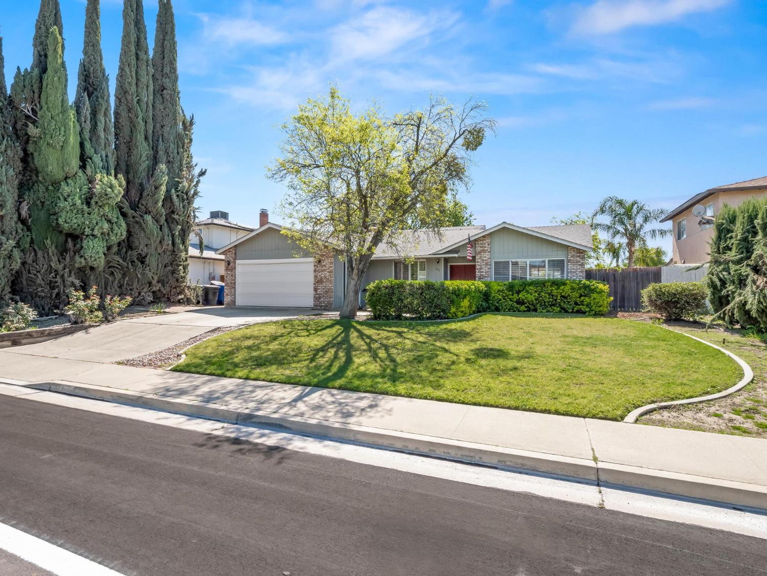 873 Cedar Lane Lemoore, CA 93245 - Photo 2 of 41 a view of a house with a garden and pathway
